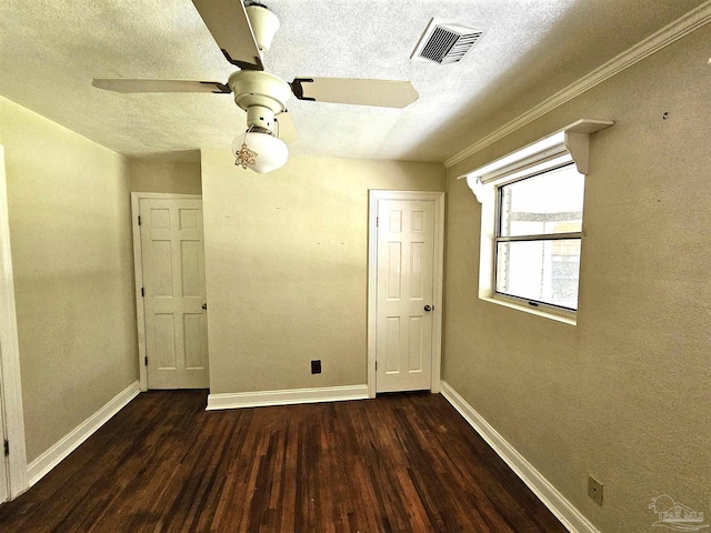 unfurnished bedroom featuring ceiling fan, dark hardwood / wood-style floors, and a textured ceiling