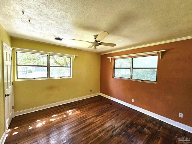 spare room with ceiling fan, dark hardwood / wood-style floors, and a textured ceiling