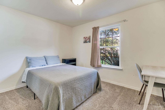 carpeted bedroom with baseboards