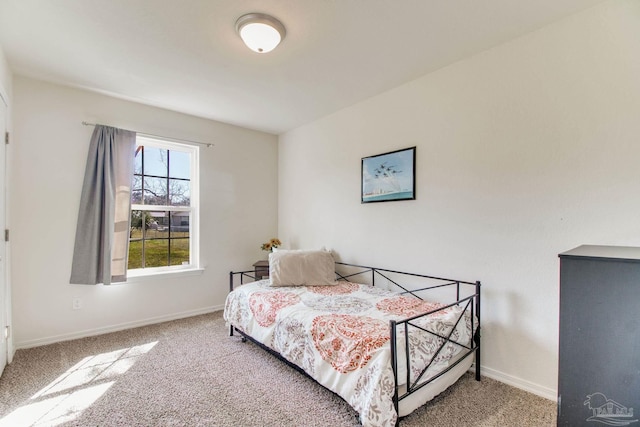 carpeted bedroom featuring baseboards