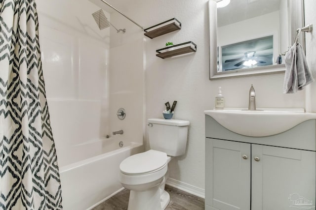 full bathroom featuring baseboards, toilet, shower / tub combo with curtain, wood finished floors, and vanity