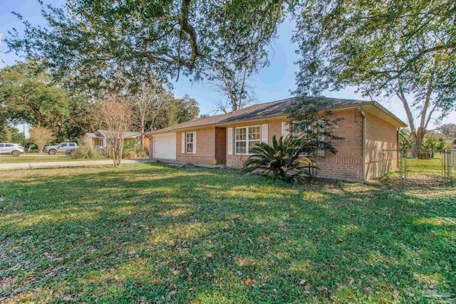 ranch-style house featuring brick siding, a front lawn, an attached garage, and fence