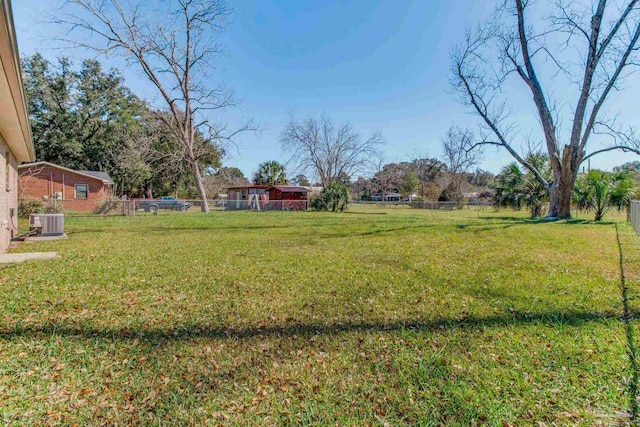 view of yard featuring cooling unit and fence