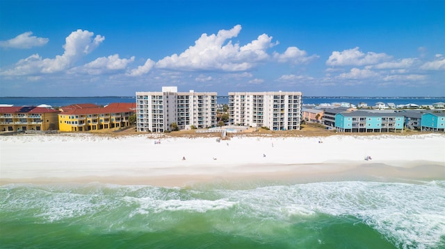 drone / aerial view featuring a water view and a view of the beach