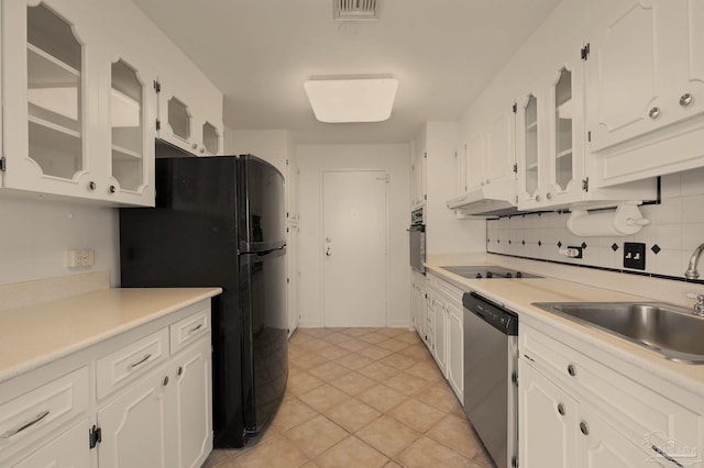 kitchen featuring light tile patterned flooring, sink, black appliances, white cabinets, and decorative backsplash