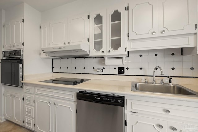 kitchen featuring white cabinetry, black appliances, sink, and backsplash