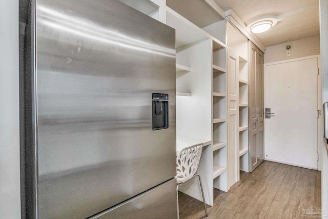 224 E Garden St Unit 236, Pensacola, FL 32502 - kitchen with light wood-type flooring and stainless steel fridge with ice dispenser