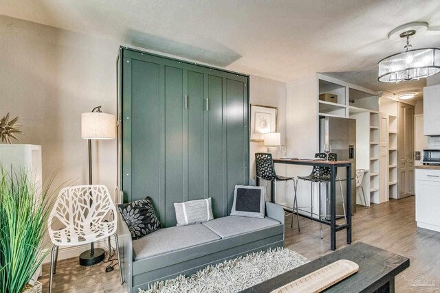 224 E Garden St Unit 236, Pensacola, FL 32502 - sitting room with an inviting chandelier and light hardwood / wood-style floors