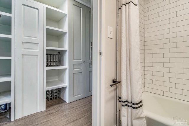 224 E Garden St Unit 236, Pensacola, FL 32502 - bathroom featuring shower / bathtub combination with curtain and wood-type flooring