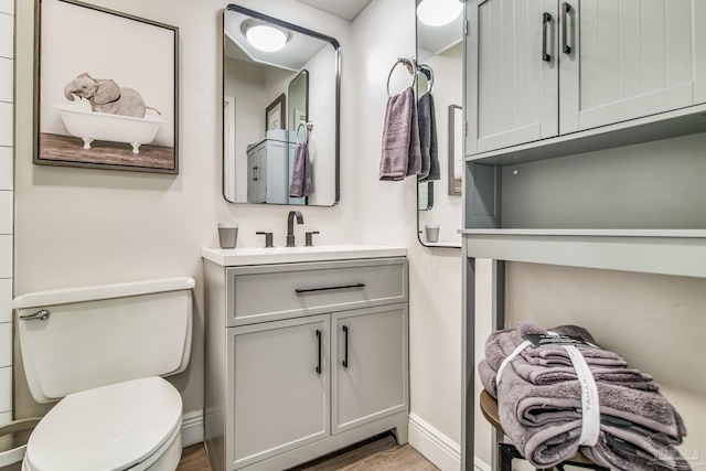224 E Garden St Unit 236, Pensacola, FL 32502 - bathroom featuring vanity, wood-type flooring, and toilet