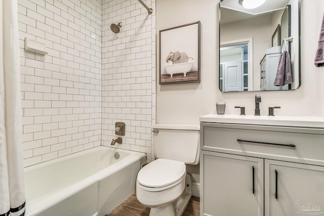 224 E Garden St Unit 236, Pensacola, FL 32502 - full bathroom featuring vanity, toilet, hardwood / wood-style floors, and shower / bath combo with shower curtain