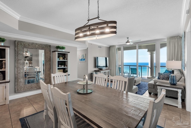 dining space with tile patterned flooring, a textured ceiling, ceiling fan, and crown molding