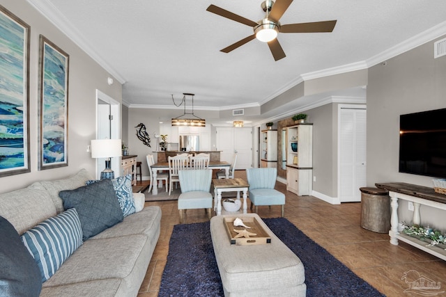 tiled living room with a textured ceiling, ceiling fan, and crown molding