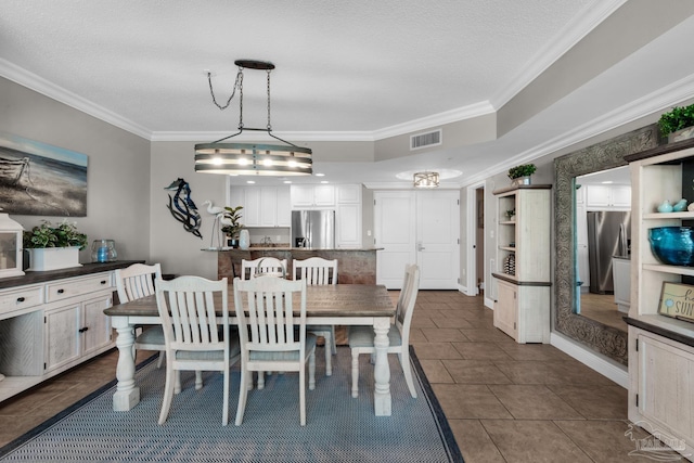 dining room with a textured ceiling, crown molding, dark tile patterned flooring, and a notable chandelier