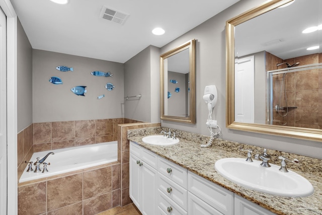 bathroom featuring tile patterned floors, plus walk in shower, and vanity