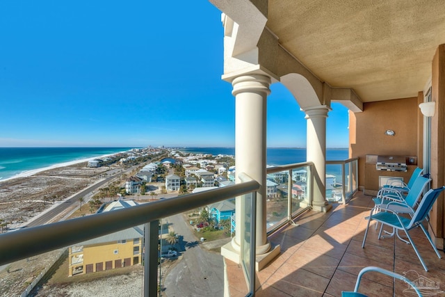 balcony featuring a water view and a beach view