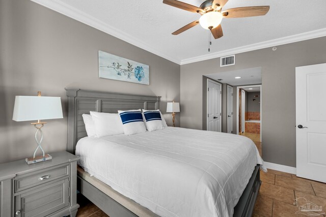 tiled bedroom with a textured ceiling, ceiling fan, and crown molding