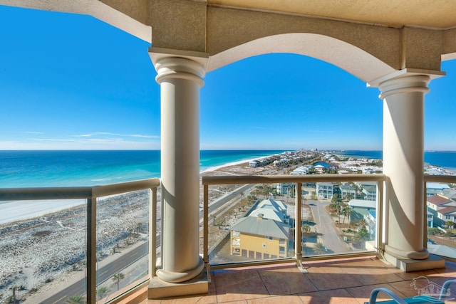 balcony with a water view and a beach view