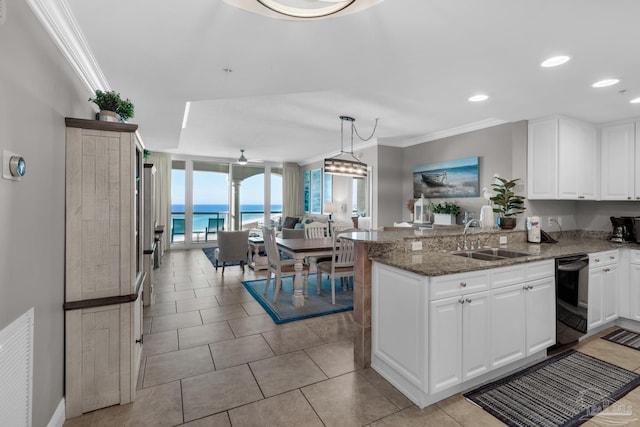 kitchen featuring white cabinetry, a water view, kitchen peninsula, and sink