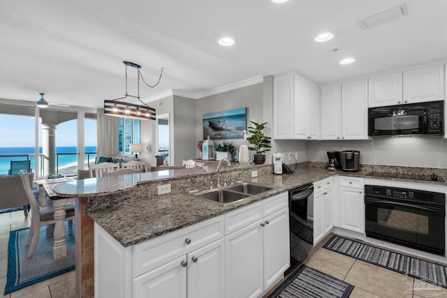 kitchen featuring kitchen peninsula, sink, a water view, and black appliances