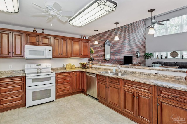 kitchen featuring pendant lighting, sink, white appliances, ceiling fan, and brick wall