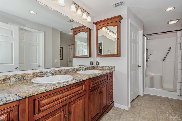 bathroom featuring vanity and walk in shower