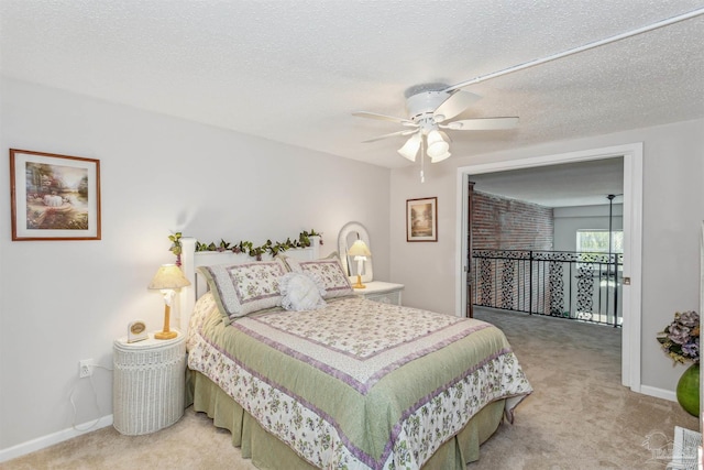 bedroom with ceiling fan, carpet, and a textured ceiling