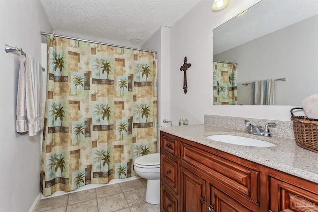 bathroom with vanity, tile patterned flooring, toilet, and a textured ceiling