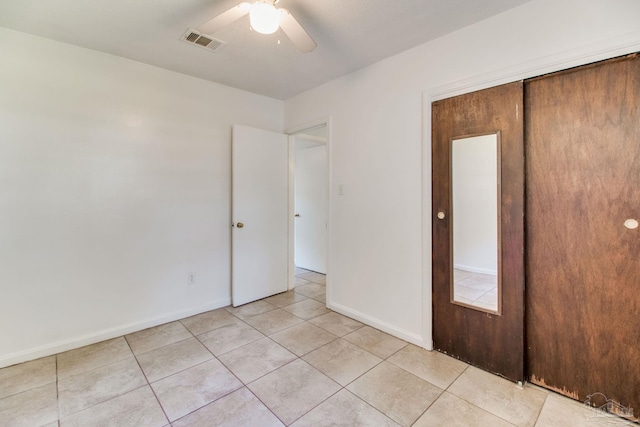 unfurnished room with visible vents, baseboards, ceiling fan, and light tile patterned flooring