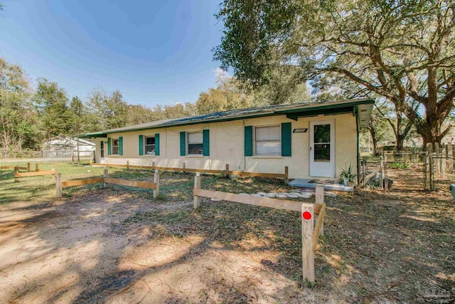 single story home with fence