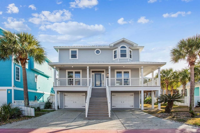 coastal inspired home with a porch and a garage