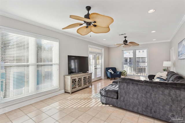 tiled living room with french doors, ceiling fan, and ornamental molding