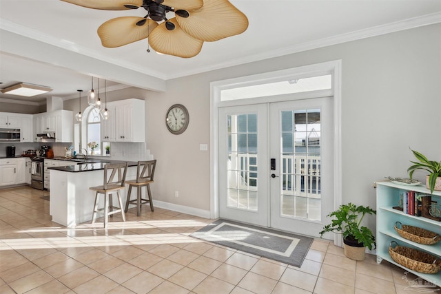 doorway to outside featuring crown molding and french doors