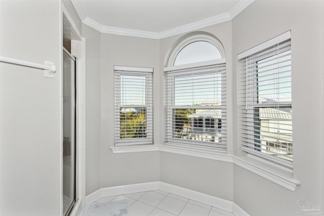 interior space with tile patterned flooring, an enclosed shower, and ornamental molding