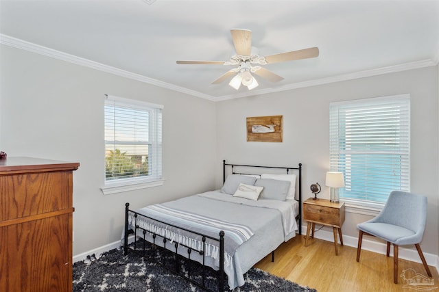 bedroom featuring multiple windows, ceiling fan, crown molding, and wood-type flooring