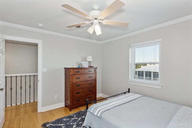 bedroom featuring ceiling fan, light wood-type flooring, and crown molding