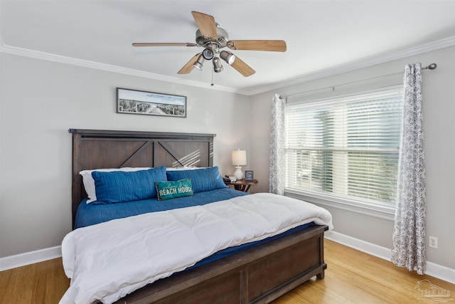 bedroom with ceiling fan, light hardwood / wood-style flooring, and multiple windows