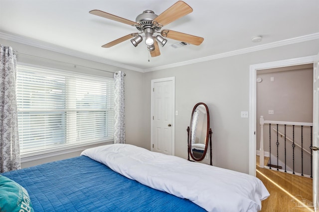 bedroom featuring ceiling fan and crown molding