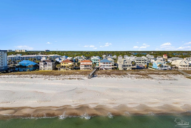 drone / aerial view featuring a beach view and a water view