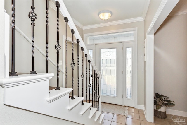 entrance foyer with ornamental molding and light tile patterned flooring