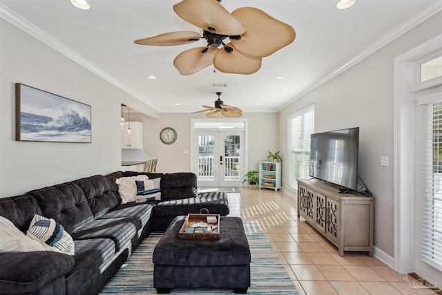 living room with ceiling fan, light tile patterned floors, ornamental molding, and french doors