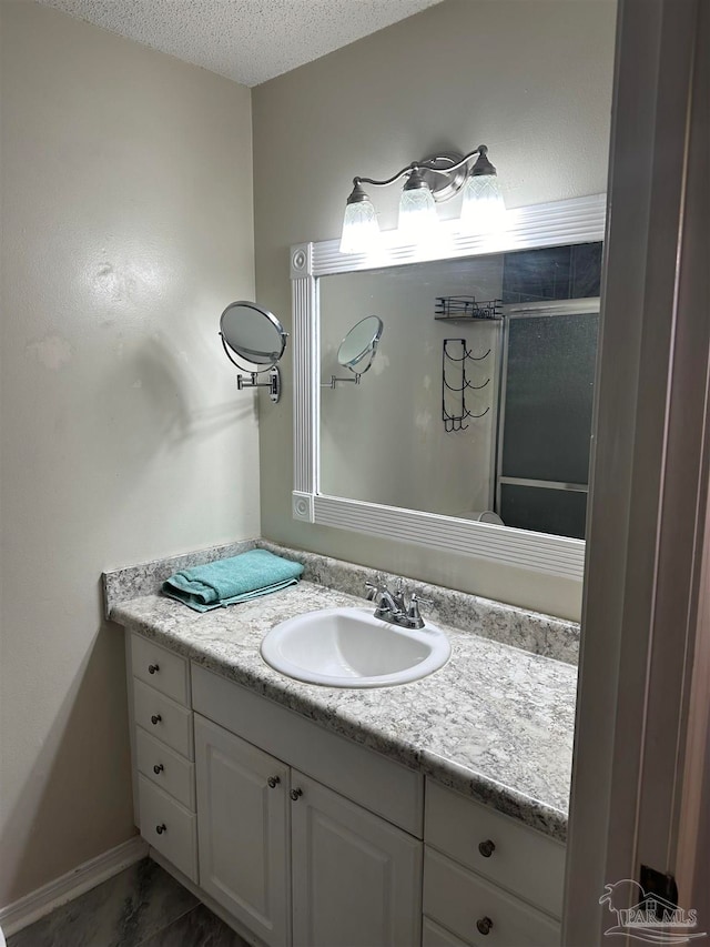 bathroom with a textured ceiling and vanity