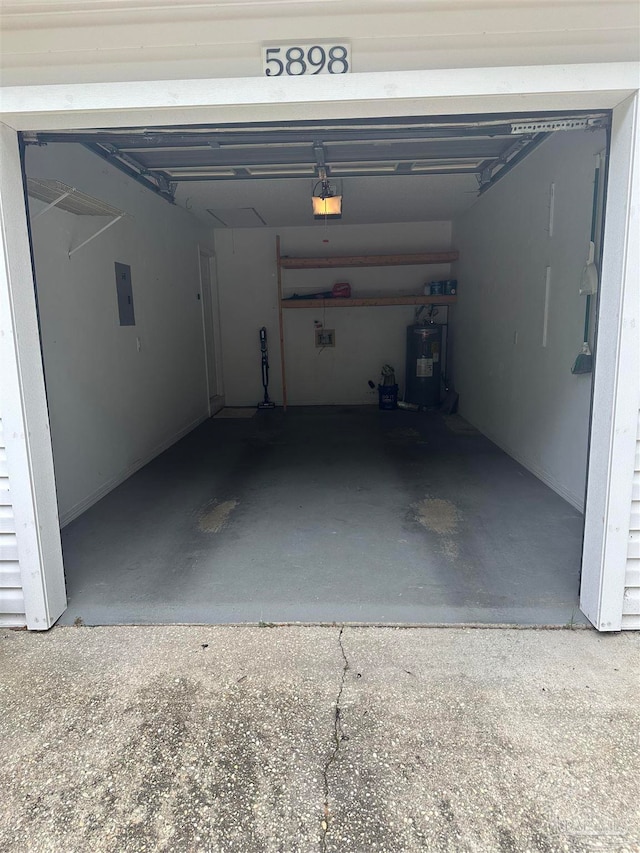 garage with a garage door opener and electric water heater