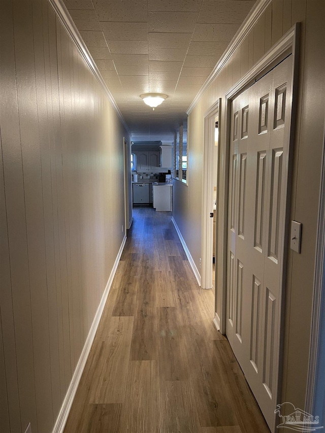 hall featuring crown molding and hardwood / wood-style flooring