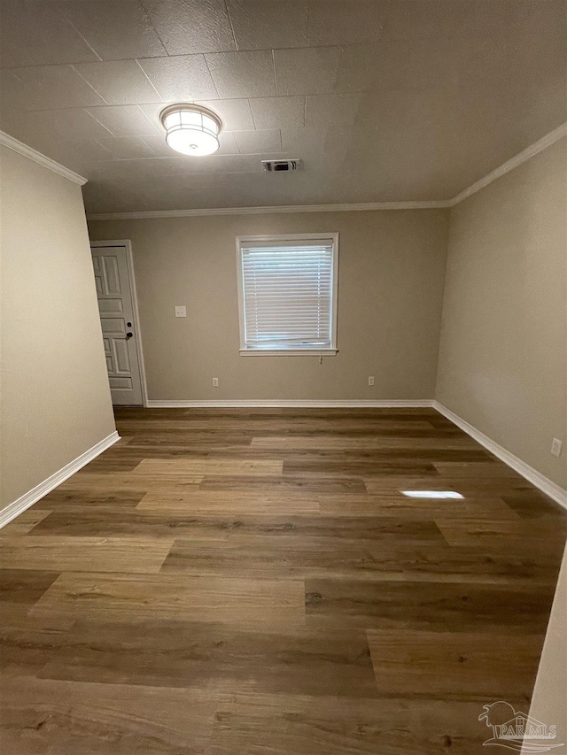 unfurnished room featuring crown molding and wood-type flooring