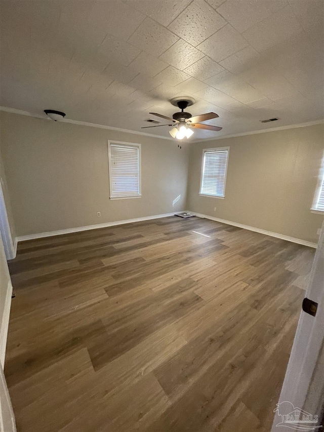 spare room featuring ceiling fan, ornamental molding, and dark hardwood / wood-style flooring