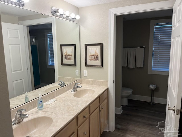 154 Ethel Wingate Dr Unit 210, Pensacola, FL 32507 - full bath featuring wood finished floors, toilet, double vanity, and baseboards