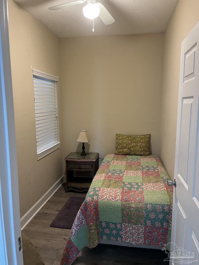 154 Ethel Wingate Dr Unit 210, Pensacola, FL 32507 - bedroom with wood finished floors, a ceiling fan, and baseboards