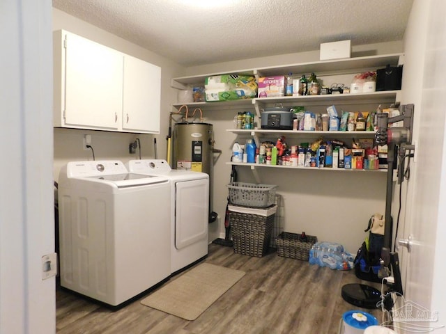 laundry area featuring washer and clothes dryer, wood-type flooring, a textured ceiling, and water heater