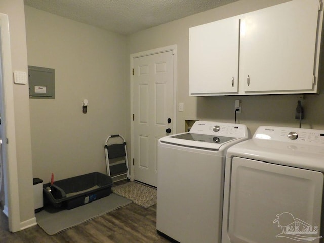 washroom with separate washer and dryer, dark wood-type flooring, cabinets, and a textured ceiling